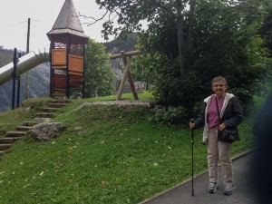 Doree and Karen bought titanium walking sticks to help with the hikes. Doree named hers "Henry". Here she stands near a children's play structure in Gimmelwald.