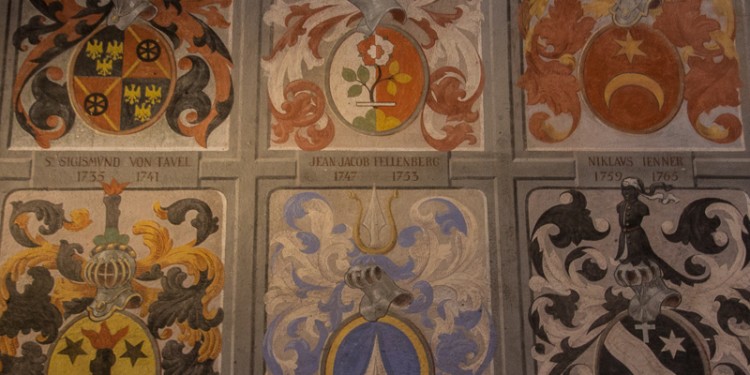 Various coats of arms painted on the wall of a room in Castle Chillon.