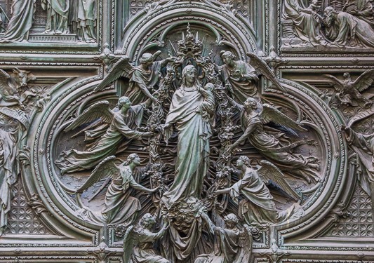 In the center of the door is this beautiful carving of Mary, the mother of Jesus, holding her baby, surrounded by attending angels.