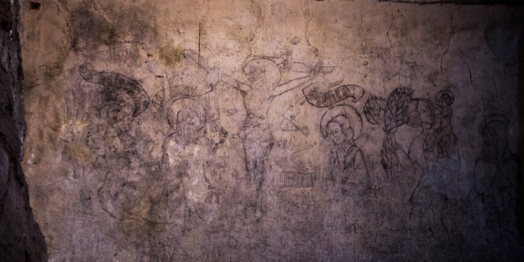 Some prisoners were able to draw on the dungeon walls. This drawing, made by prisoners, is thought to contain an image of Christ on the cross and other religious figures.